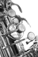 A fragment of the valve of the saxophone in black and white