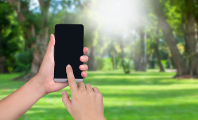 hand hold smart phone with black  screens display on the garden