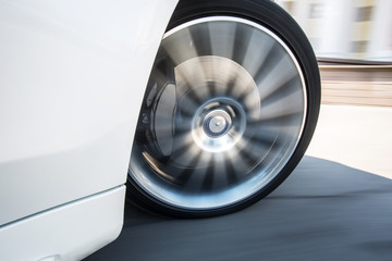 Closeup of spining car wheel in the corner