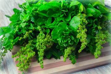 fresh spinach leaves on a wooden kitchen board