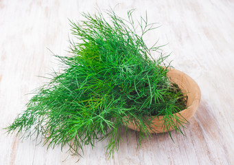 fresh dill on wooden table