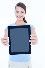 Smiling woman showing her tablet looking at camera