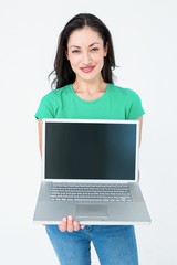 Smiling brunette showing her laptop