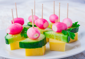 party finger foods with cheese, cucumber and radish