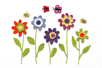 gehäkelte Blumen mit Schmetterlingen und Bienen