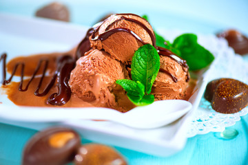 Brown chocolate ice cream scoops with topping