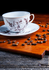 Coffee beans and cup on wooden table