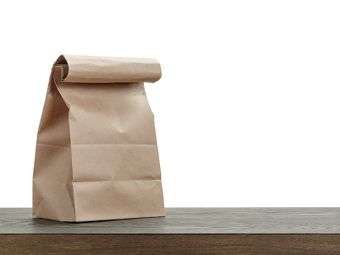 simple brown paper bag for lunch or food on wooden table