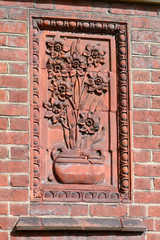 Victorian Flower Tile decoration on outside wall of house