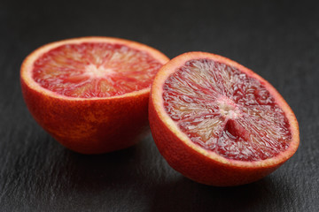 red sicilian oranges sliced on slate board