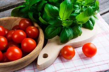Fresh cherry tomatoes and basil leaves