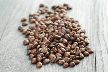 freshly roasted coffee beans on wooden table
