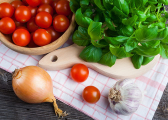 Fresh cherry tomatoes and basil leaves
