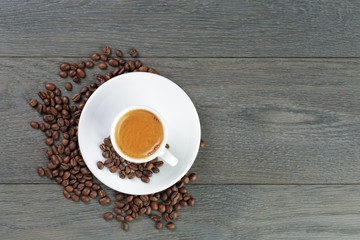 feshly made espresso with coffee beans on wooden table