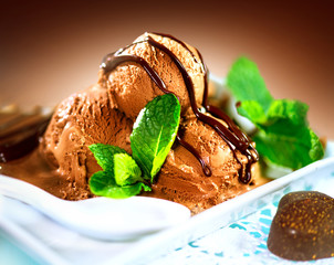 Brown chocolate icecream scoops with topping