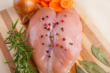 Raw chicken breast on cutting board