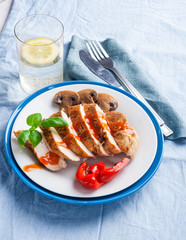 Baked chicken breast sliced on plate