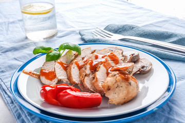 Baked chicken breast sliced on plate