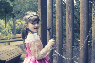 Little girl in her princess costume playing a giant xylophone © inigocia