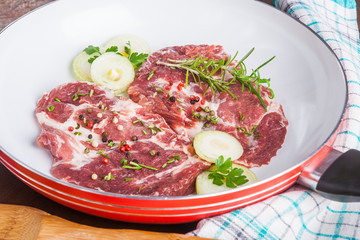 Raw pork chops in the pan