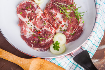 Raw pork chops in the pan