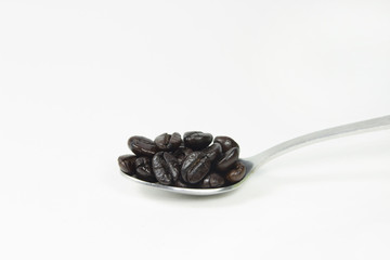 coffee bean in stainless spoon on white screen