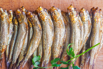 Smoked sprats on cutting board