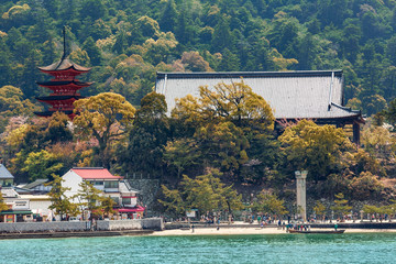 Pagoda roof and Itsukushima shrine on shore of Miyajima, Japan