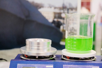 Laboratory equipment. Green chemical substance in the beaker