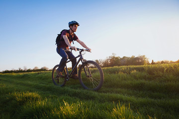 outdoor sport, young man riding bicycle in the nature