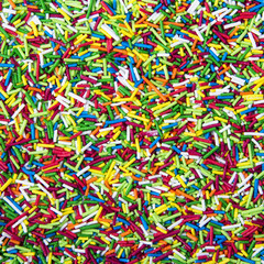 Mix of colorful Sugar sticks powder background
