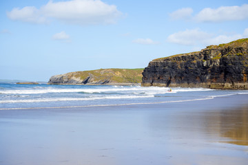 bright winter view of kayaker at ballybunion sandy beach
