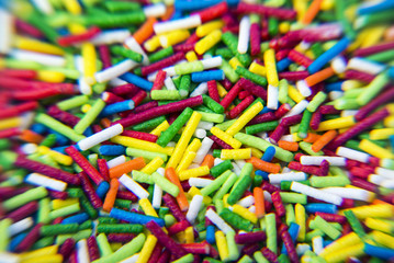 Fototapeta na wymiar Macro of Sugar colorful sticks powder background