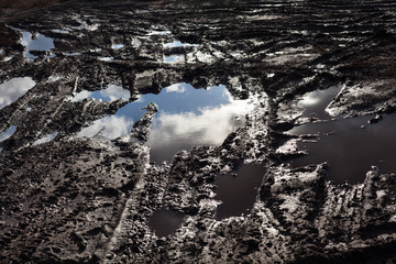 Mud and puddles on the dirt road