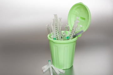 Green Garbage can with medical waste