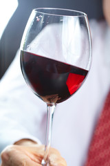 man handing glass of wine