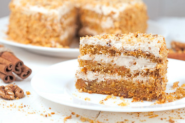 Slice of gourmet carrot cake with walnut crumbs and cinnamon