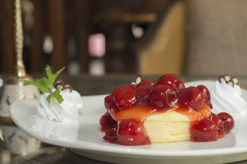 Dessert ,Cheesecake with Berries Sauce and Green Mint on desk in