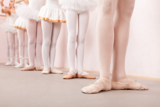 Group of  little ballerinas practicing ballet with their teacher