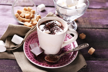Hot chocolate with marshmallows in mug, on color wooden background