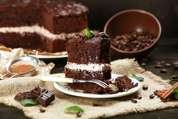 Delicious chocolate cake on table on brown background