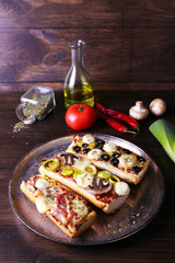 Different sandwiches with vegetables and cheese on metal tray on table close up