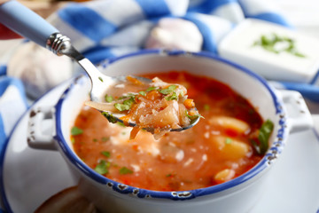 Ukrainian beetroot soup - borscht, on blue napkin, on wooden background