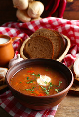 Ukrainian beetroot soup - borscht, on napkin, on wooden background