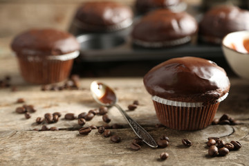Tasty homemade chocolate muffins on wooden table