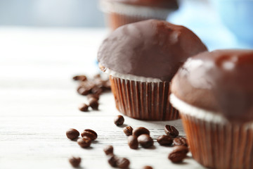 Tasty homemade chocolate muffins on wooden table