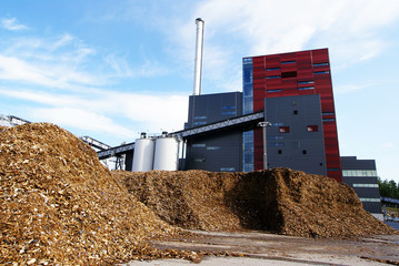 bio power plant with storage of wooden fuel (biomass) against bl - obrazy, fototapety, plakaty