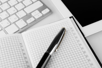 Office workplace with tablet and computer close up