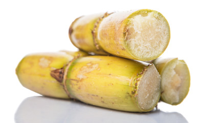 Cut sugarcane stalks over white background