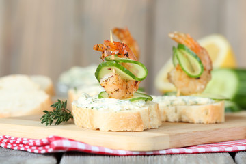 Appetizer canape with shrimp and cucumber on table close up